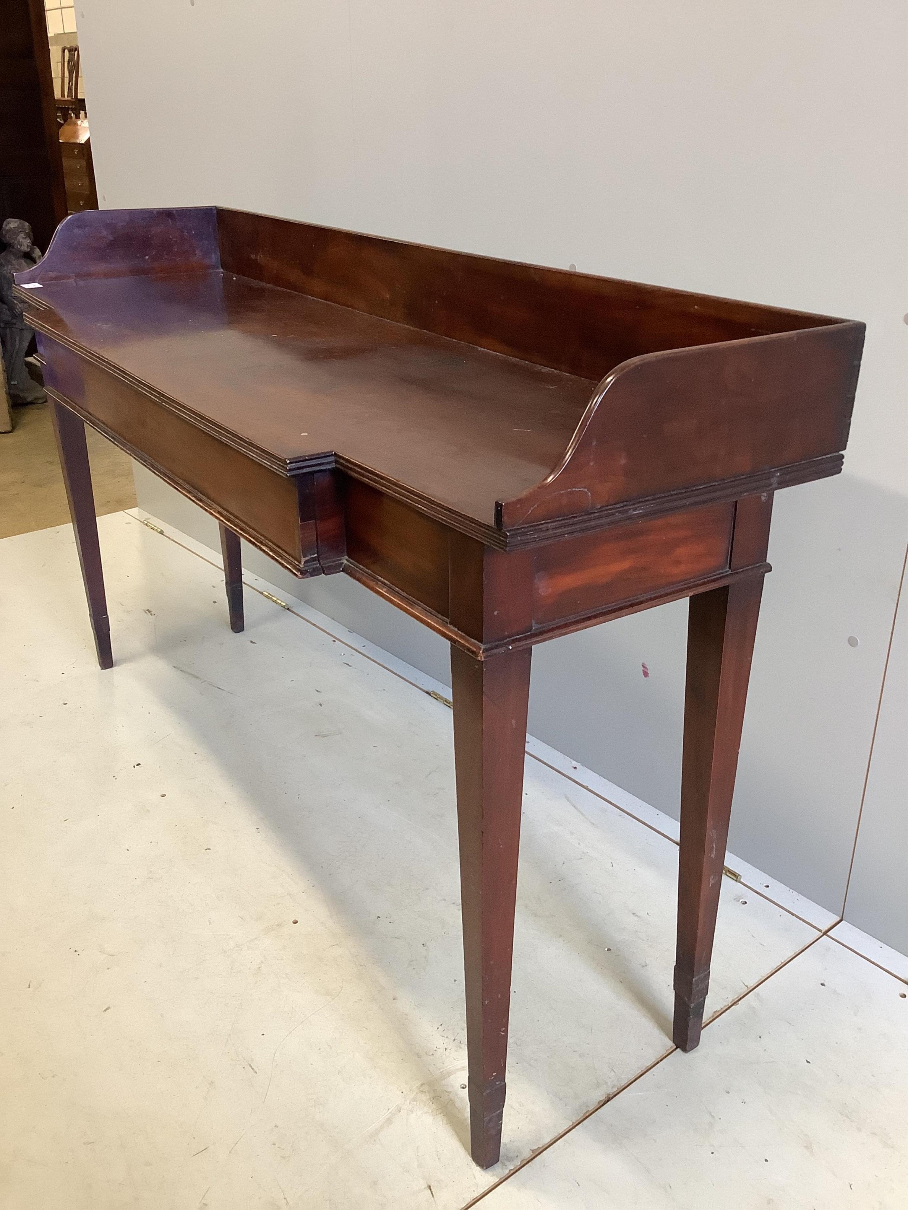 A George III mahogany breakfront serving table, with a three quarter galleried top, width 162cm, depth 48cm, height 93cm. Condition - fair